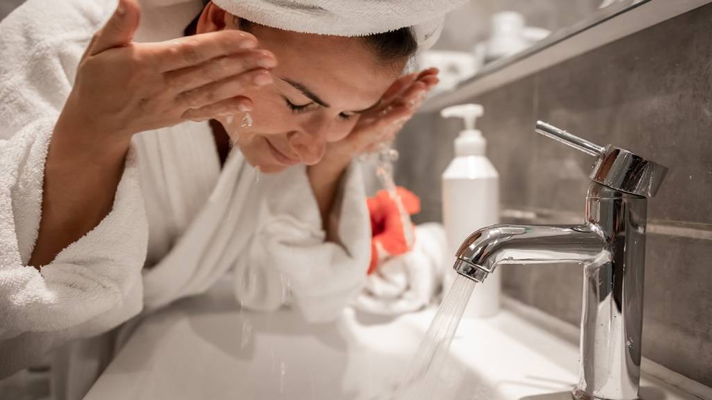 young-beautiful-woman-bathroom-with-towel-her-head-washes-her-face-with-tap-water.jpg